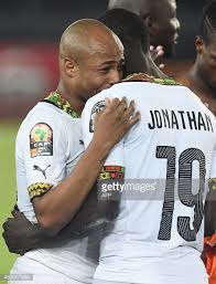 Jonathan Mensah offers support to injured Andre Ayew
